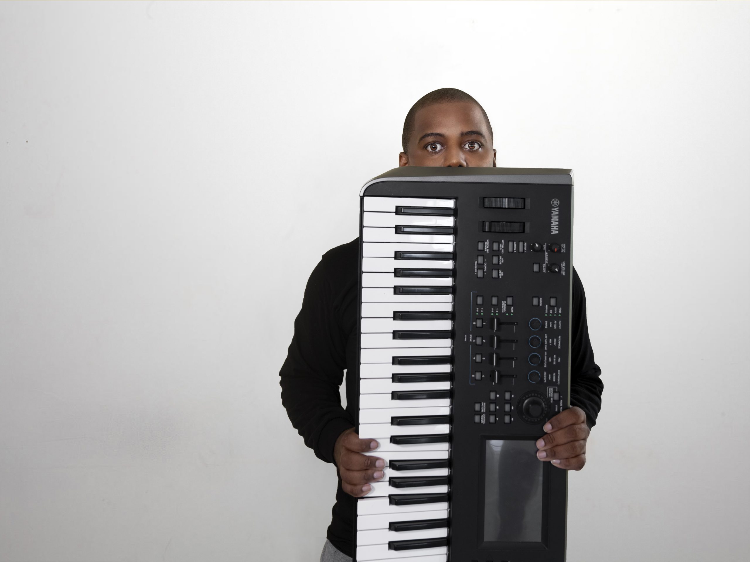 Mr Ridge holding a Yamaha keyboard upright